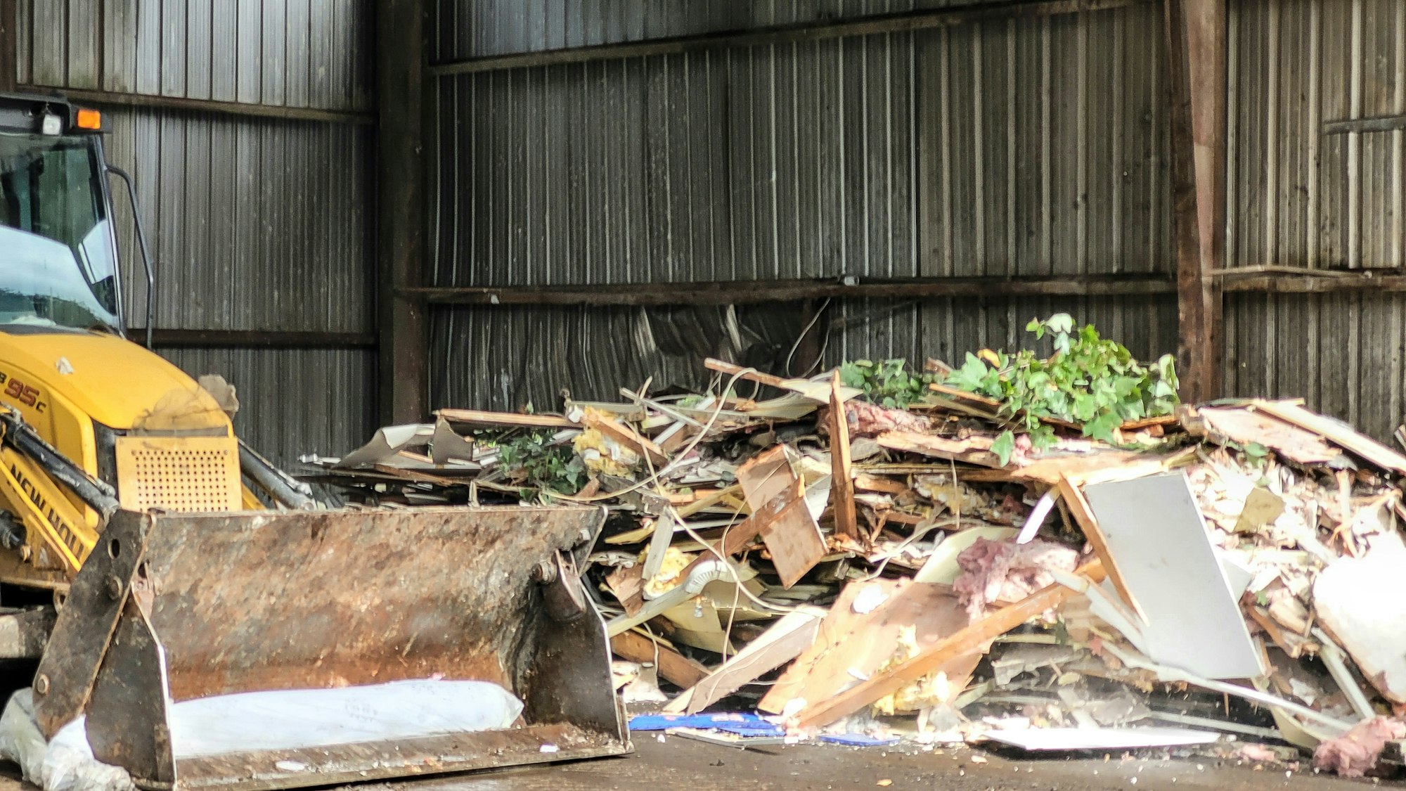 Bulldozer at trash disposal site ready to sort trash for removal to another site.